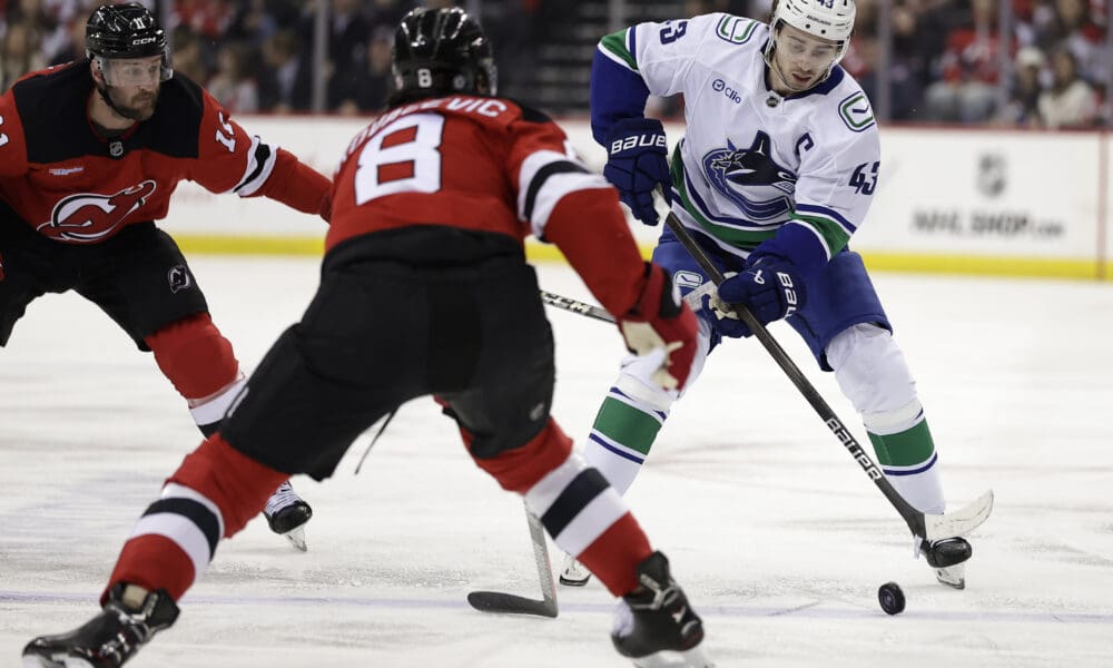 Quinn Hughes Eyes Devils Reunion to Play with Jack Hughes and Luke